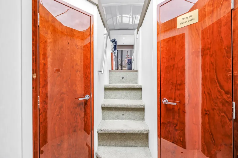 Slide: The Image of Interior of 2017 Sea Ray Sundancer 460 yacht with wooden doors and carpeted stairs. - 34