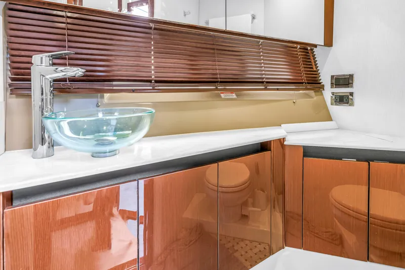 Slide: The Image of Luxurious bathroom interior of 2017 Sea Ray Sundancer 460 yacht with glass sink and wooden cabinets. - 46