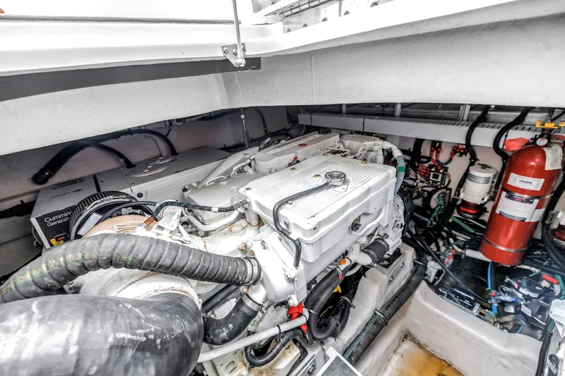 Slide: The Image of Engine room of 2017 Sea Ray Sundancer 460 yacht, featuring Cummins generator and fire extinguisher. - 54