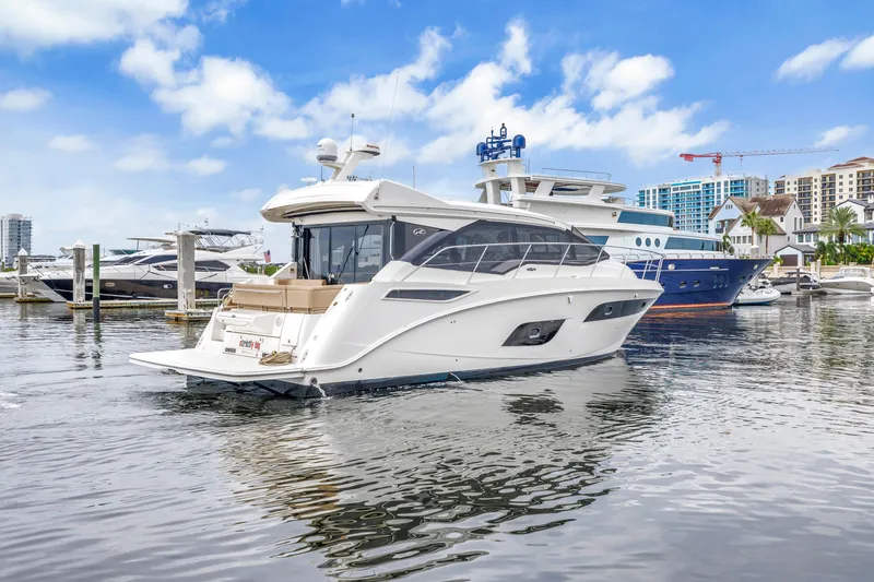 Slide: The Image of 2017 Sea Ray Sundancer 460 yacht docked in a marina with clear skies. - 7