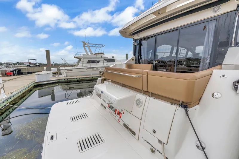 Slide: The Image of 2017 Sea Ray Sundancer 460 yacht docked at marina under blue sky. - 8