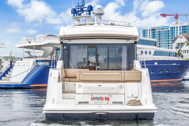 Slide: The Image of 2017 Sea Ray Sundancer 460 yacht docked at marina, surrounded by other luxury boats. - 9