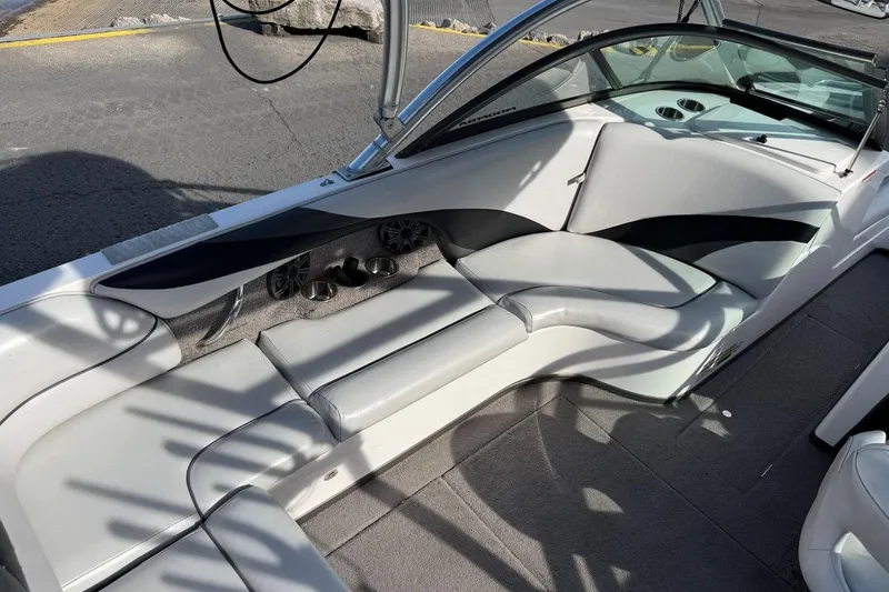 Slide: The Image of 2008 Moomba Mobius LSV boat interior with gray seating and cup holders. - 11