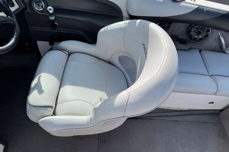 Slide: The Image of 2008 Moomba Mobius LSV boat interior with gray captain's chair and dashboard controls. - 16