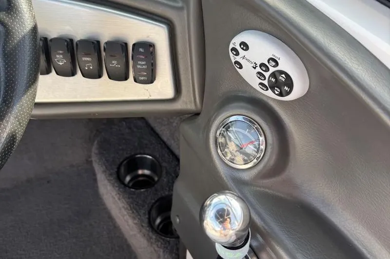 Slide: The Image of 2008 Moomba Mobius LSV dashboard with control panel and switches. - 19