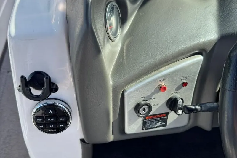 Slide: The Image of 2008 Moomba Mobius LSV dashboard controls with ignition and audio system buttons. - 20