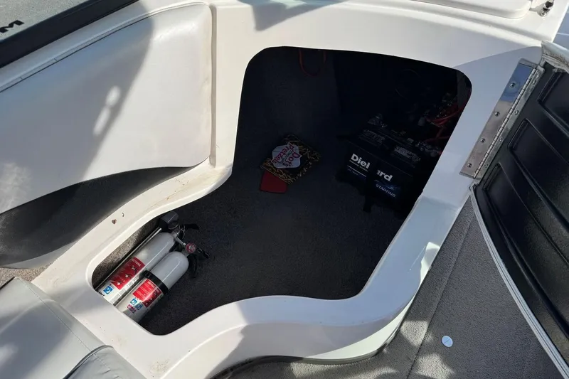 Slide: The Image of 2008 Moomba Mobius LSV storage compartment with fire extinguishers and DieHard battery. - 30