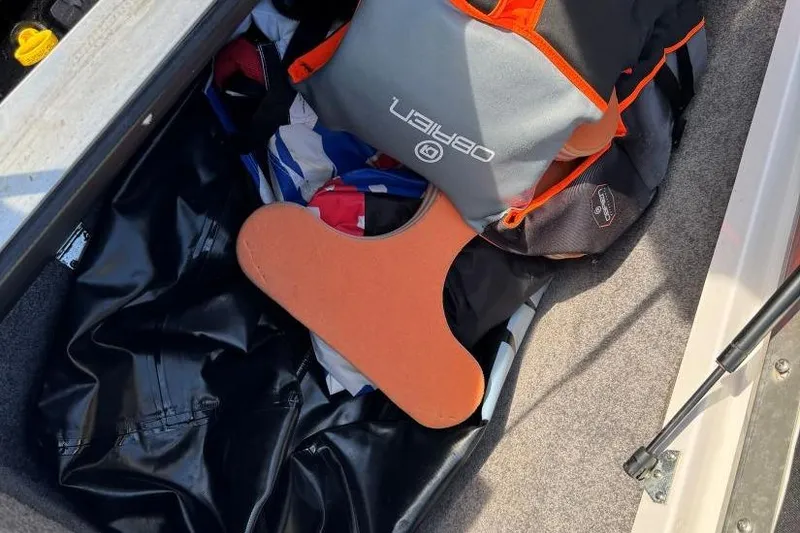 Slide: The Image of Storage compartment in a 2008 Moomba Mobius LSV with life jacket and boating gear. - 38