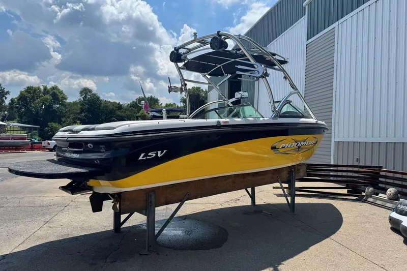 Slide: The Image of 2008 Moomba Mobius LSV boat on display, yellow and black, with a wakeboard tower. - 5
