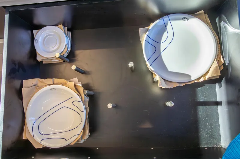 Slide: The Image of Ceramic plates and bowls in a drawer on a 2018 Cranchi Eco Trawler 53 Long Distance. - 102