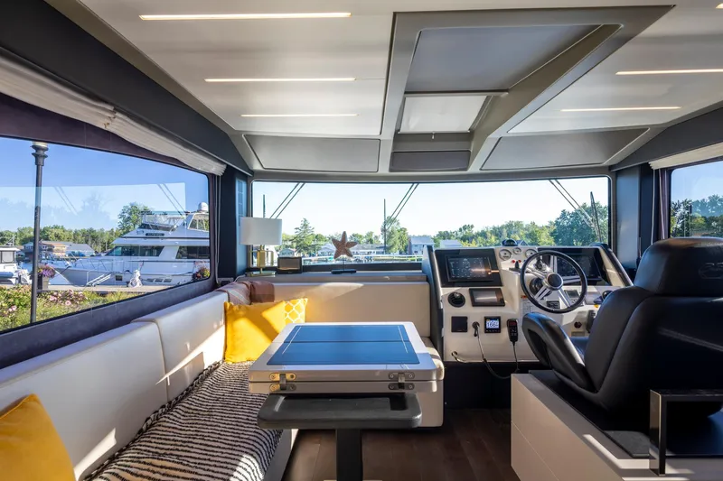 Slide: The Image of Interior of 2018 Cranchi Eco Trawler 53 Long Distance, featuring helm and seating area. - 104