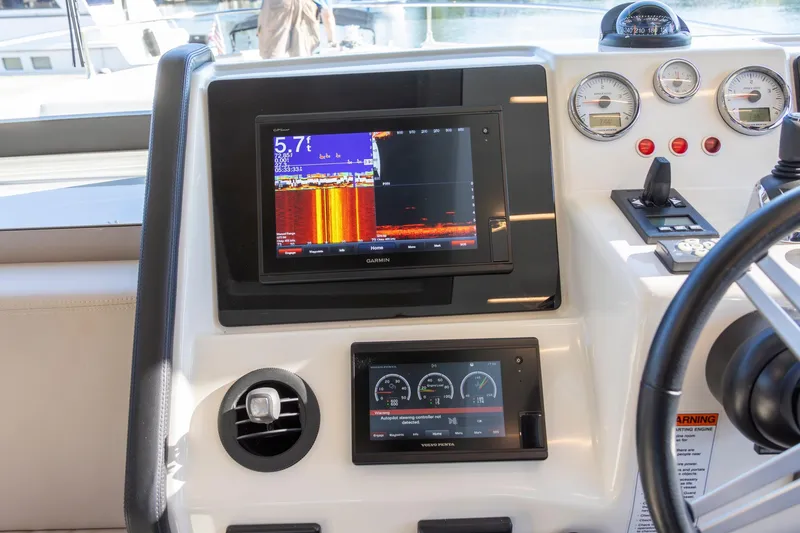 Slide: The Image of 2018 Cranchi Eco Trawler 53 Long Distance helm with navigation and control displays. - 110