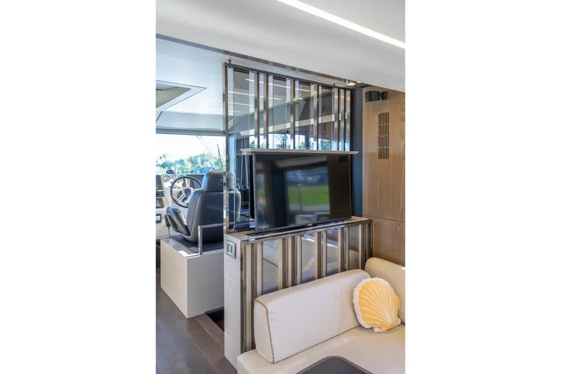 Slide: The Image of Interior of 2018 Cranchi Eco Trawler 53, featuring modern helm and cozy seating area. - 121