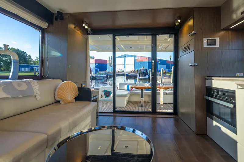 Slide: The Image of Interior of 2018 Cranchi Eco Trawler 53, featuring modern design and waterfront view. - 123