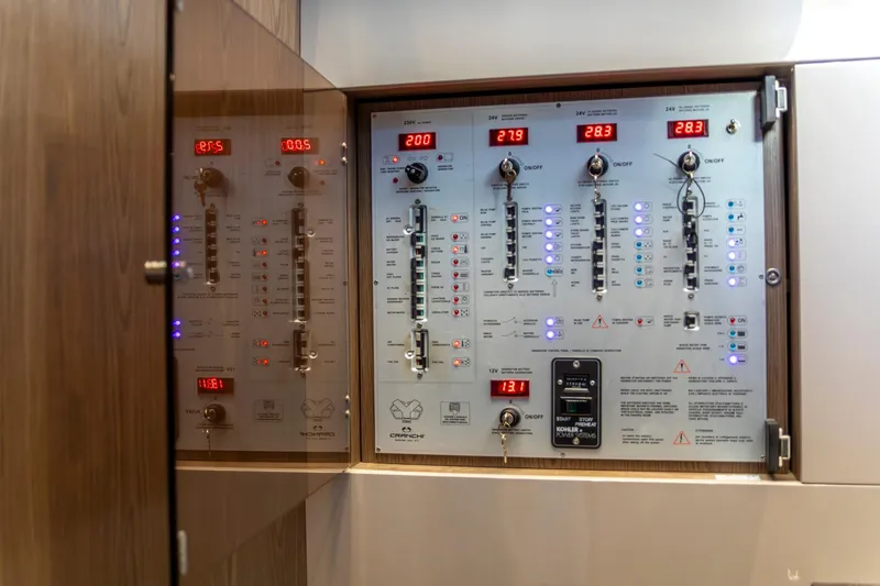 Slide: The Image of Control panel of 2018 Cranchi Eco Trawler 53 Long Distance yacht, featuring digital displays and switches. - 128