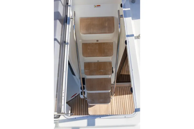 Slide: The Image of Staircase on 2018 Cranchi Eco Trawler 53 Long Distance yacht, featuring wooden steps and metal railings. - 13