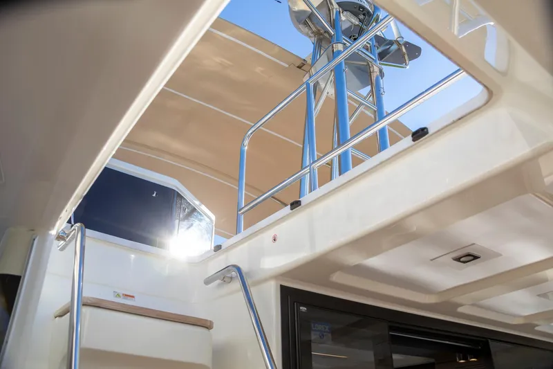 Slide: The Image of 2018 Cranchi Eco Trawler 53 Long Distance interior with stairs and railing, under sunny sky. - 14
