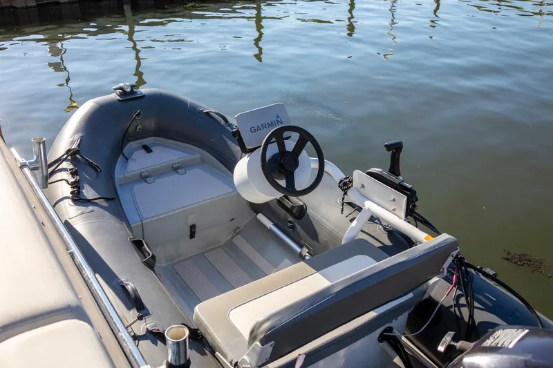 Slide: The Image of Inflatable boat with Garmin steering, docked beside Cranchi Eco Trawler 53 Long Distance, 2018 model. - 149
