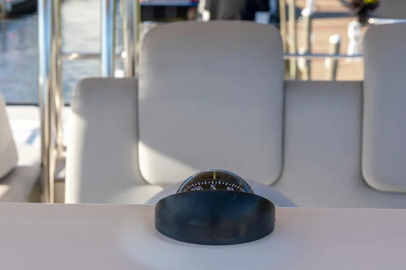Slide: The Image of Compass on 2018 Cranchi Eco Trawler 53 Long Distance yacht, with beige seating in background. - 30