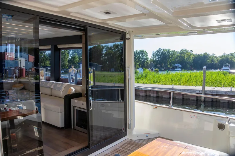 Slide: The Image of 2018 Cranchi Eco Trawler 53 Long Distance yacht interior with scenic waterfront view. - 47