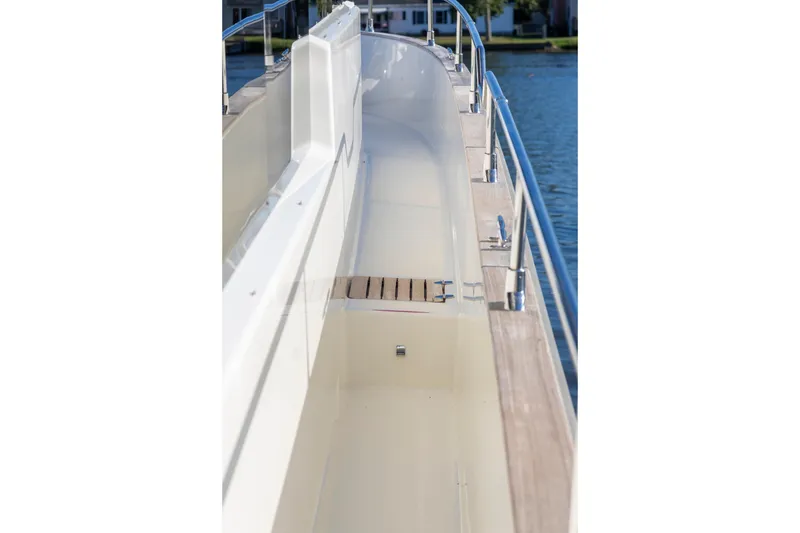 Slide: The Image of Side deck of 2018 Cranchi Eco Trawler 53 Long Distance, featuring sleek design and stainless steel railings. - 56