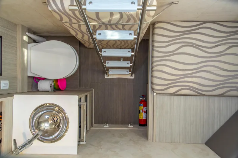 Slide: The Image of 2018 Cranchi Eco Trawler 53 Long Distance interior with toilet, sink, and ladder. - 62