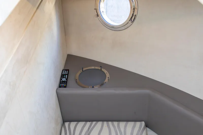 Slide: The Image of Interior of 2018 Cranchi Eco Trawler 53, featuring a porthole and remote control. - 63