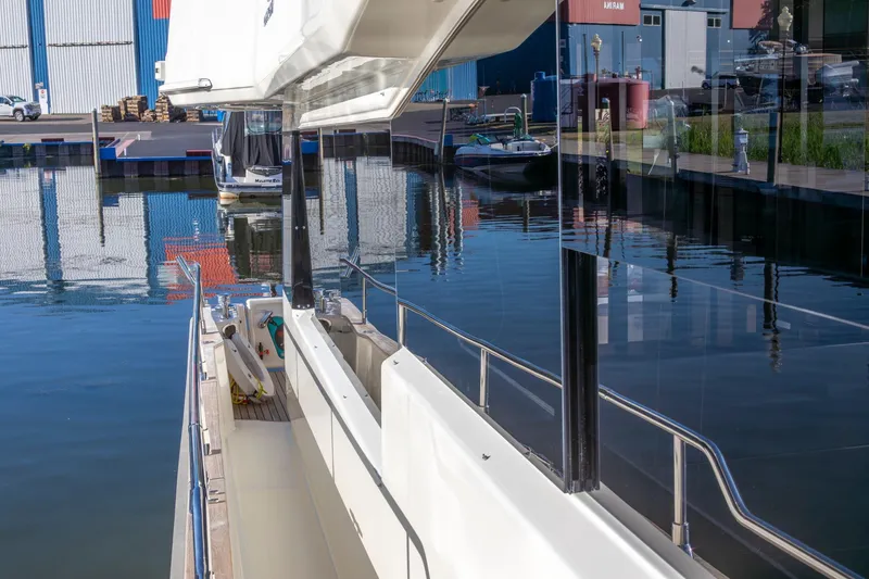 Slide: The Image of 2018 Cranchi Eco Trawler 53 Long Distance docked at marina, reflecting on calm water. - 76
