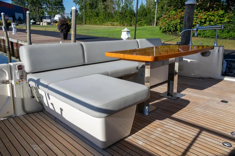 Slide: The Image of 2018 Cranchi Eco Trawler 53 Long Distance deck with seating and wooden table. - 77