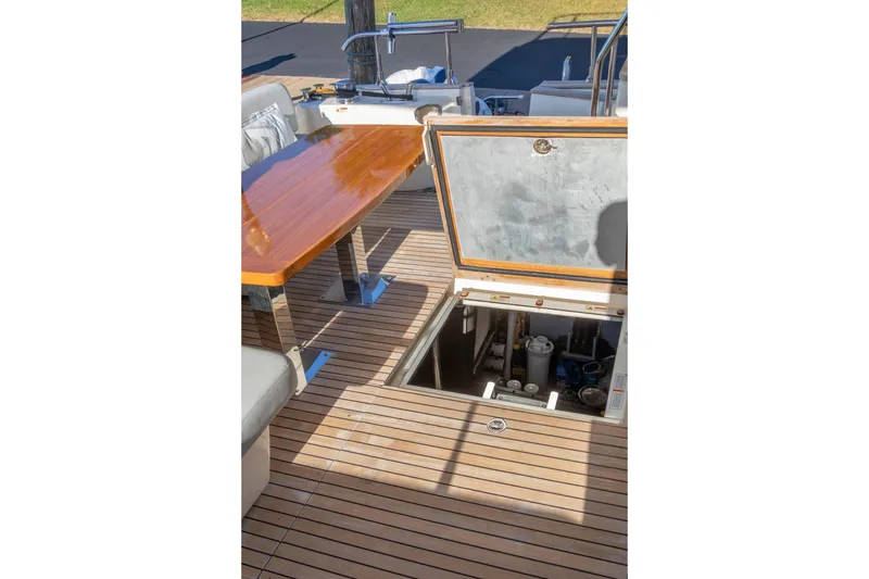 Slide: The Image of 2018 Cranchi Eco Trawler 53 Long Distance deck with open hatch and wooden table. - 78