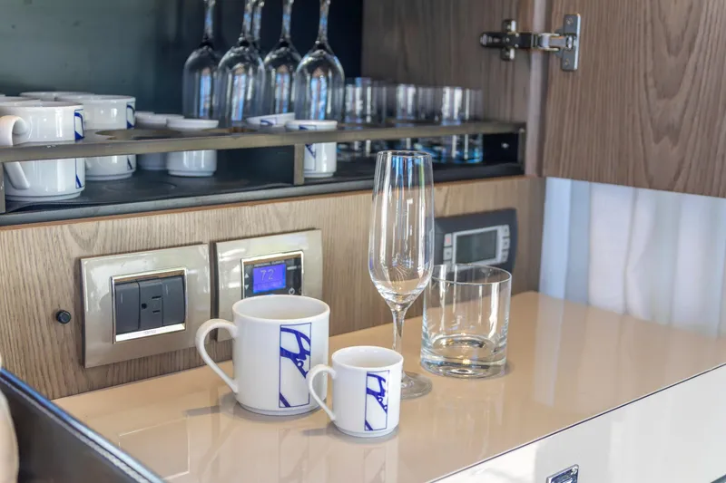 Slide: The Image of Interior of 2018 Cranchi Eco Trawler 53 with glassware and mugs in a cabinet. - 94