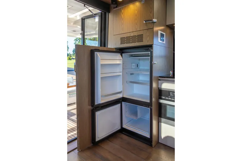 Slide: The Image of Open refrigerator inside 2018 Cranchi Eco Trawler 53 Long Distance yacht kitchen. - 97