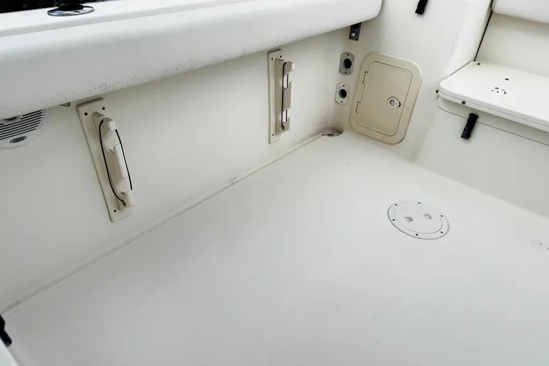 Slide: The Image of 2005 Pursuit 2870 Walkaround boat interior, featuring storage compartments and seating area. - 12