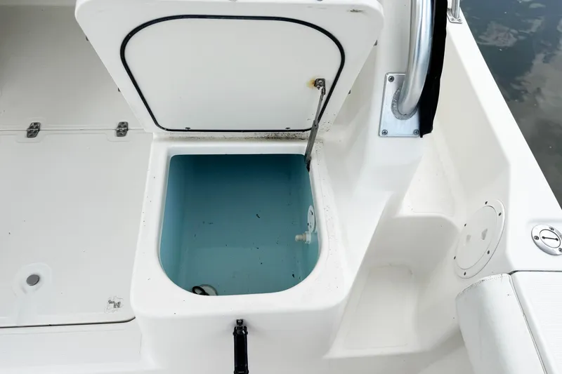 Slide: The Image of Open storage compartment on 2005 Pursuit 2870 Walkaround boat, showing interior details. - 13