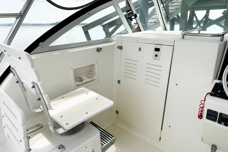 Slide: The Image of 2005 Pursuit 2870 Walkaround boat interior with seating and storage compartments. - 19