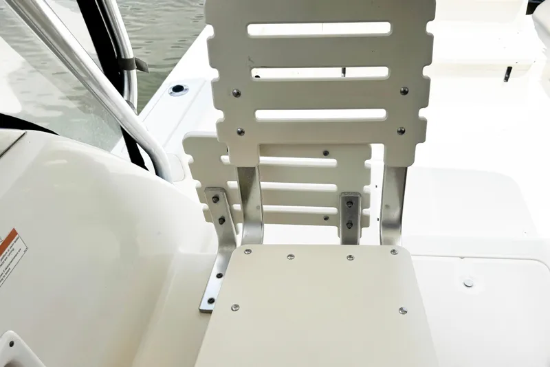 Slide: The Image of 2005 Pursuit 2870 Walkaround boat seat detail with water in background. - 21