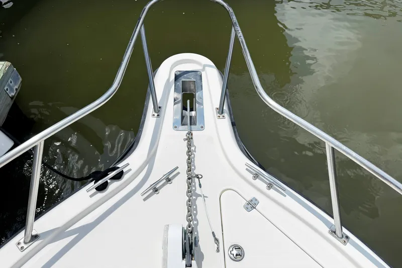 Slide: The Image of Bow of 2005 Pursuit 2870 Walkaround boat with anchor chain and railing. - 26
