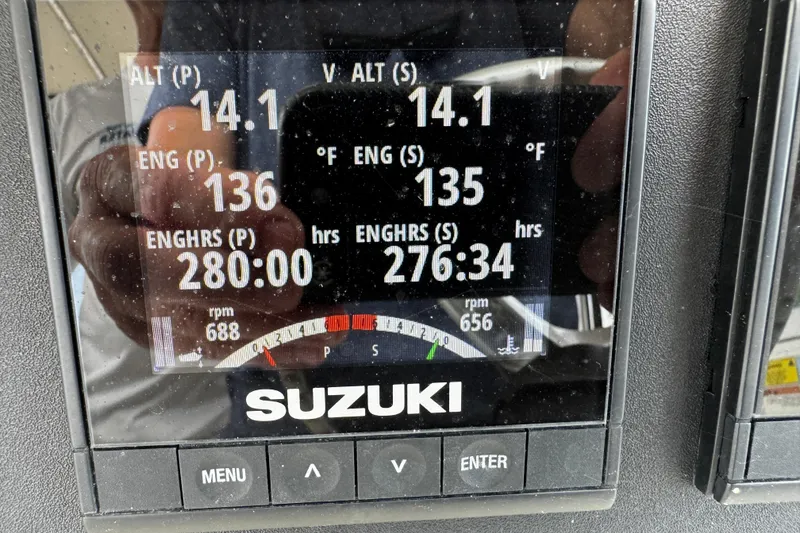Slide: The Image of Suzuki engine display on 2005 Pursuit 2870 Walkaround showing engine stats and hours. - 32