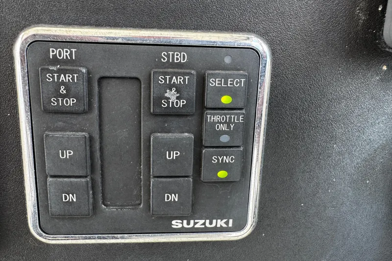 Slide: The Image of Control panel of a 2005 Pursuit 2870 Walkaround boat with Suzuki engine controls. - 33