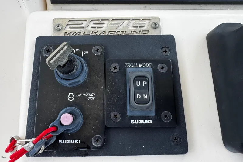 Slide: The Image of Control panel of a 2005 Pursuit 2870 Walkaround boat with Suzuki troll mode switch. - 34