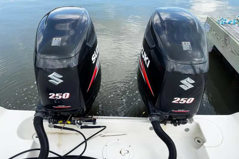 Slide: The Image of Twin Suzuki 250 outboard motors on a 2005 Pursuit 2870 Walkaround boat. - 7