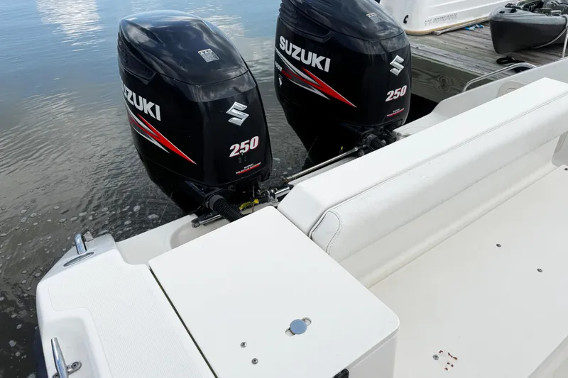 Slide: The Image of 2005 Pursuit 2870 Walkaround with twin Suzuki 250 outboard motors at dock. - 9