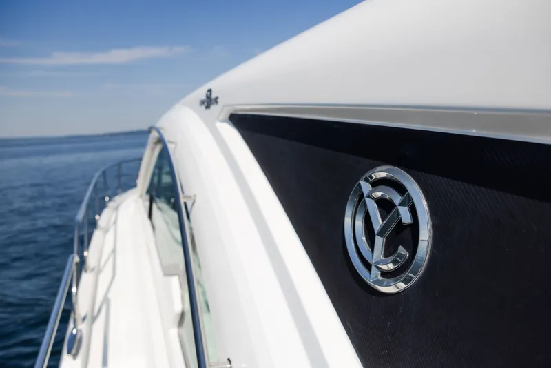 Slide: The Image of 2019 Cruisers Yachts 50 Cantius on open water, showcasing sleek design and logo. - 14
