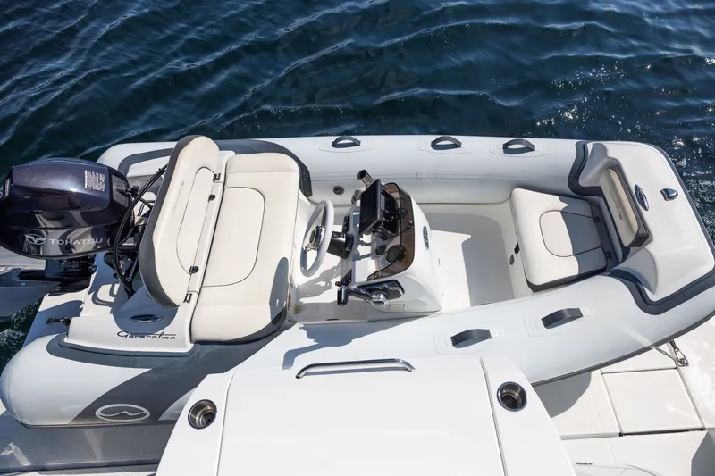 Slide: The Image of Inflatable boat with Tohatsu motor, viewed from above, near a 2019 Cruisers Yachts 50 Cantius. - 18