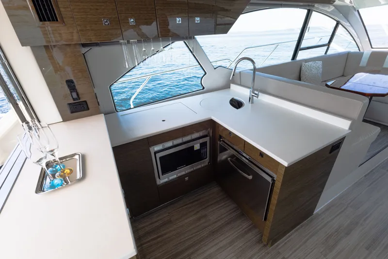 Slide: The Image of Luxurious 2019 Cruisers Yachts 50 Cantius kitchen with modern appliances and ocean view. - 20