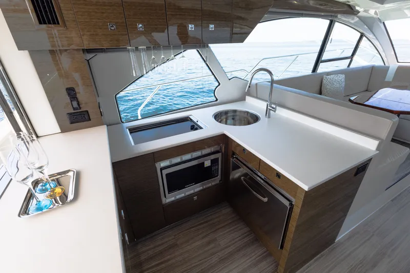 Slide: The Image of Luxurious 2019 Cruisers Yachts 50 Cantius kitchen with modern appliances and ocean view. - 21