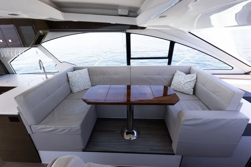 Slide: The Image of Luxurious interior of 2019 Cruisers Yachts 50 Cantius with elegant seating and wooden table. - 25