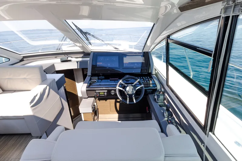 Slide: The Image of Luxurious 2019 Cruisers Yachts 50 Cantius helm with modern navigation systems and plush seating. - 28
