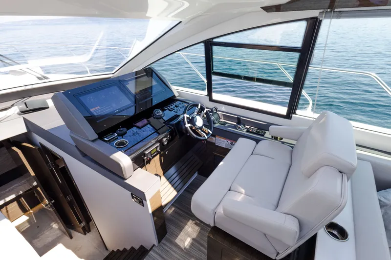 Slide: The Image of Helm of 2019 Cruisers Yachts 50 Cantius with modern controls and comfortable seating. - 30