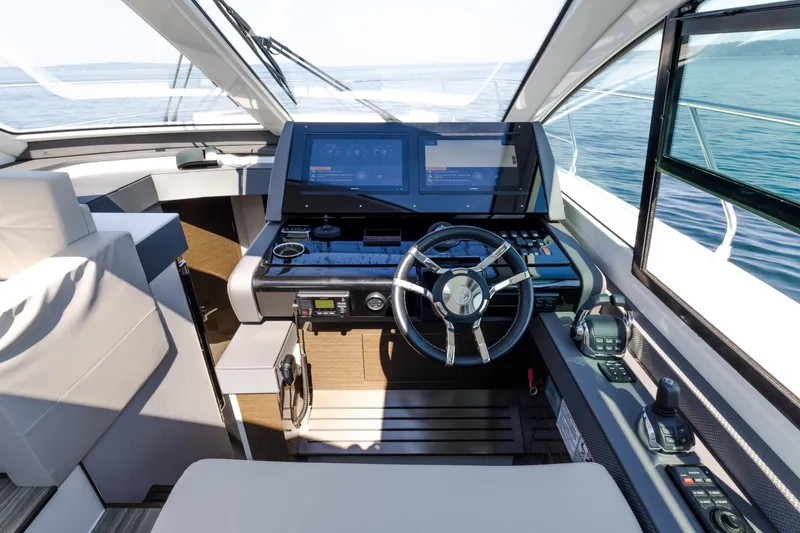 Slide: The Image of 2019 Cruisers Yachts 50 Cantius helm with modern controls and panoramic view. - 31
